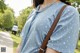 A woman wearing a blue shirt with white polka dots on it.