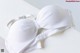 A white bra sitting on top of a white table.