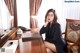 A woman sitting at a desk in front of a mirror.