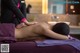 A woman getting a back massage at a spa.