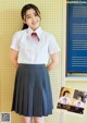 A woman in a school uniform posing for a picture.